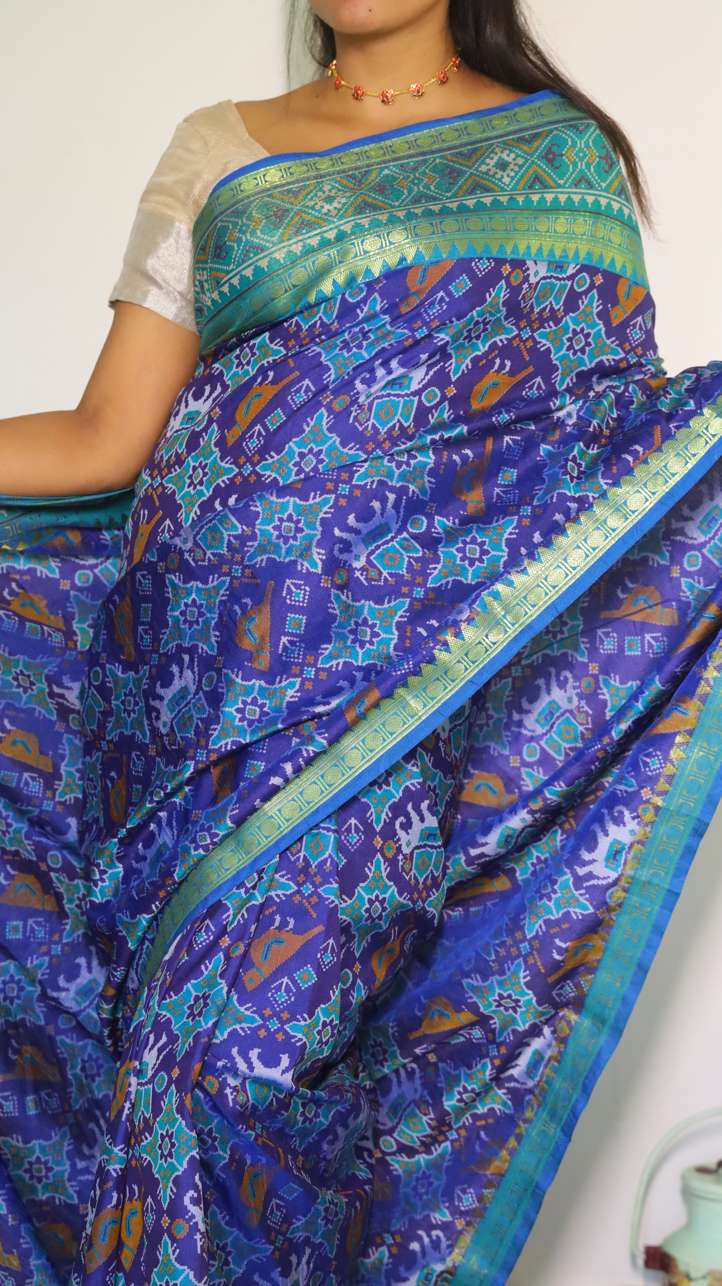 Stunning semi silk saree in blue with vibrant Patola prints with intricate border - VEDHIKA