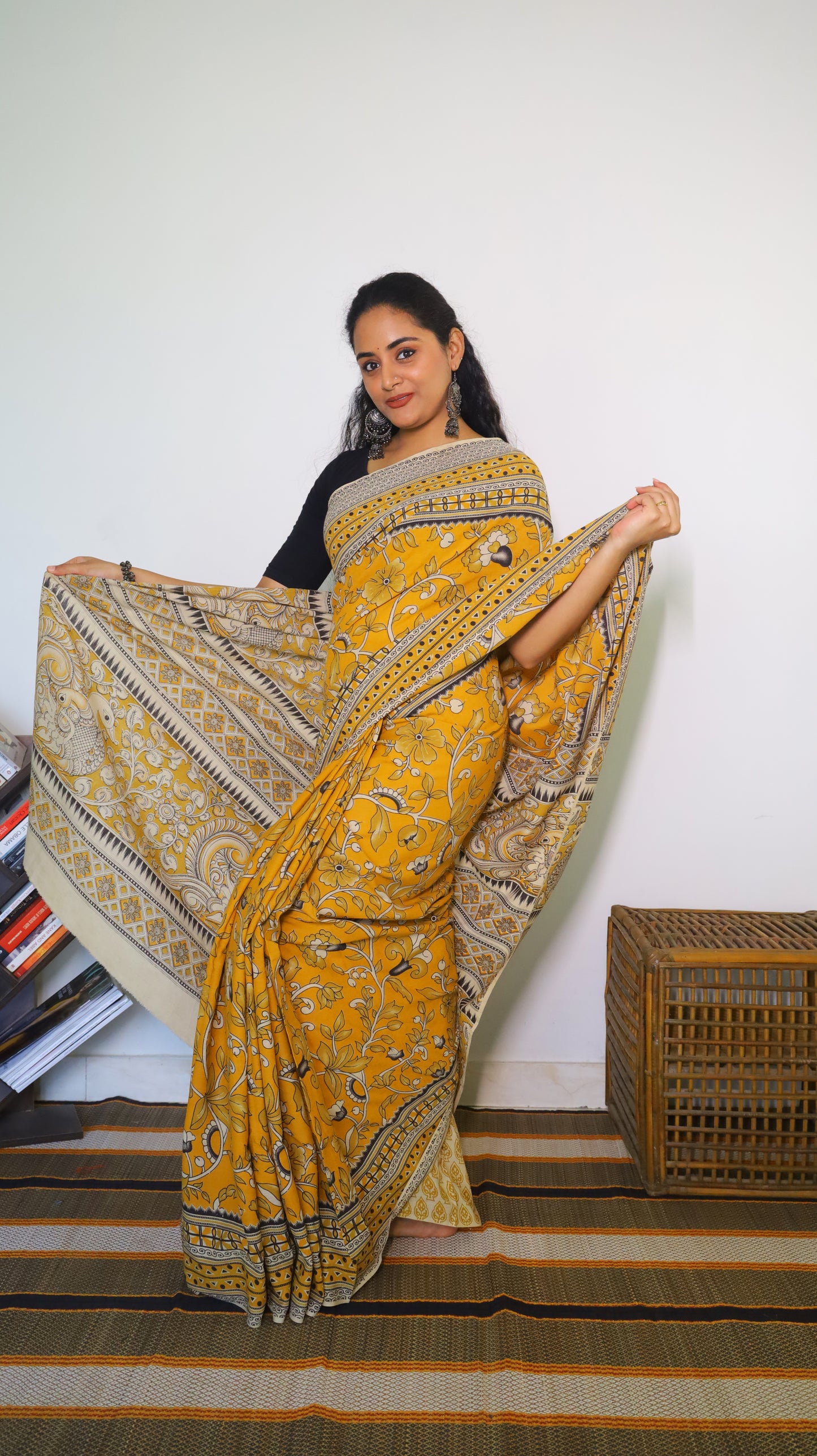 Vibrant mustard yellow soft cotton kalamkari saree featuring flowers and peacocks in light grey and black - BOOMIKA