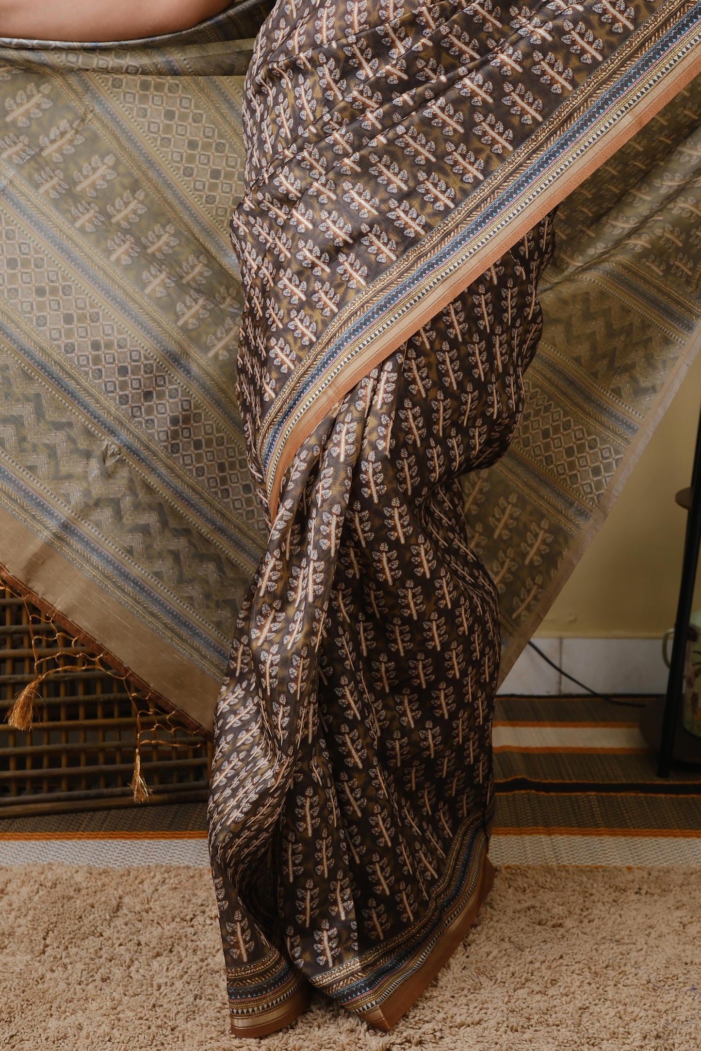 Synthetic organza in olive brown with all over ethnic prints and simple zari border - BOOMIKA
