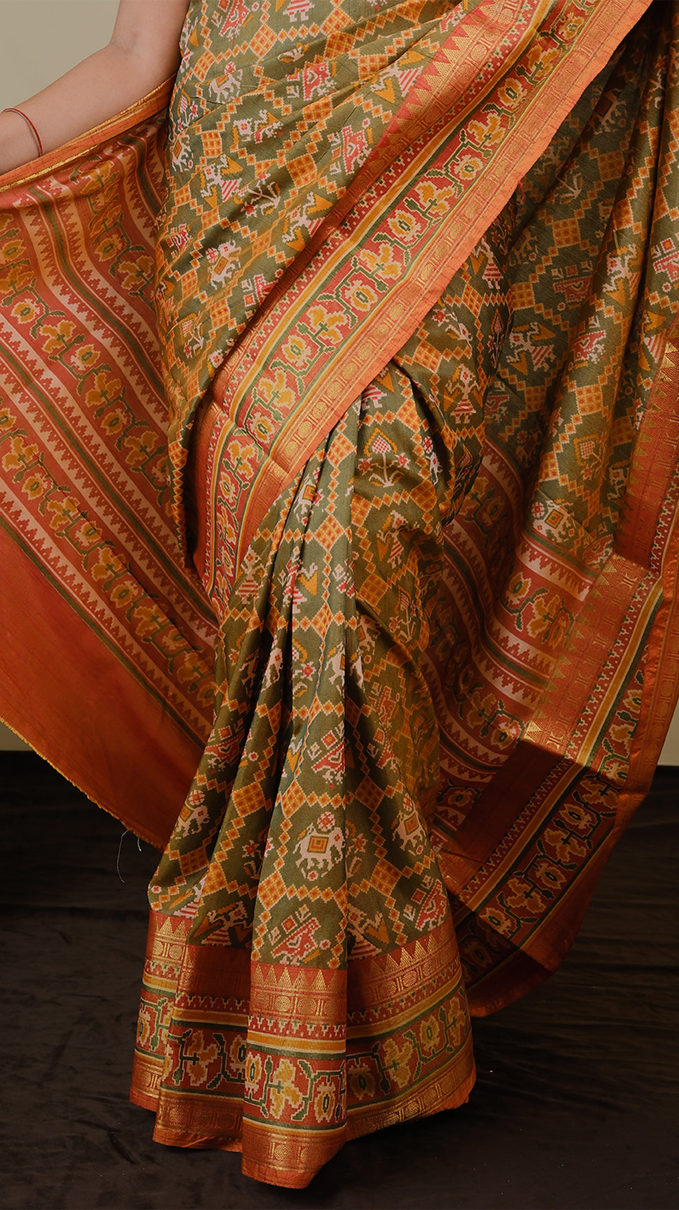Soft silk patolla print in light olive green and orange with double zari border - AVANTHIKA (20010019)