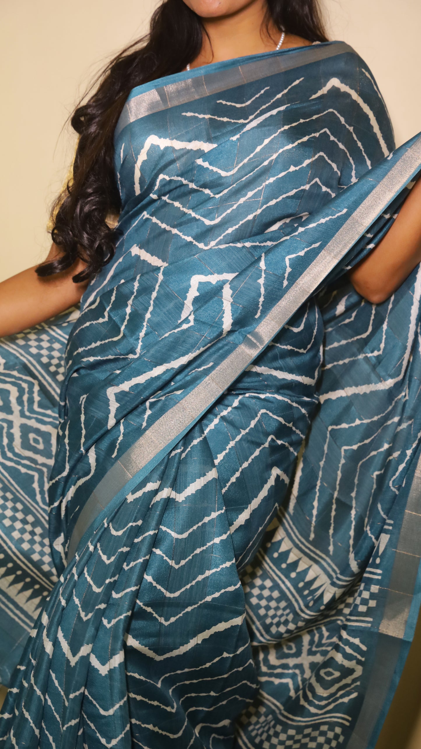 Elegant teal Chanderi Silk Cotton saree designed with bold silver chevron patterns running across the body - VEDHIKA