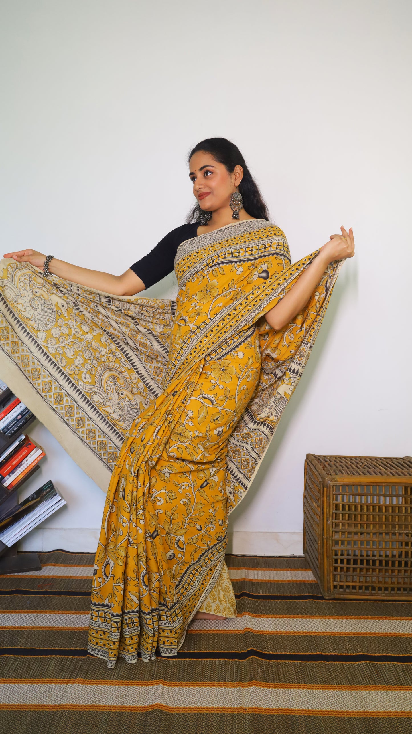 Vibrant mustard yellow soft cotton kalamkari saree featuring flowers and peacocks in light grey and black - BOOMIKA