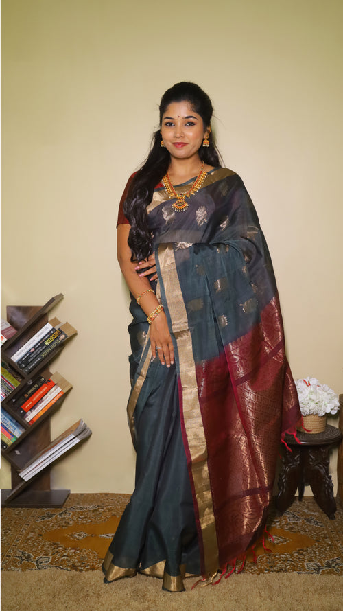 Striking Wine red and dark green meet soft silk in this traditional, handwoven floral motif saree - SWASTHIKA
