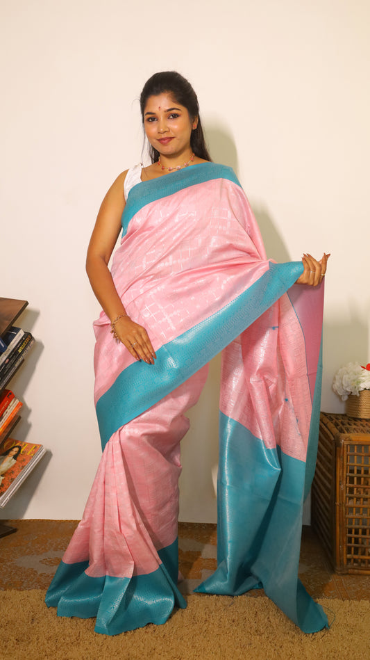 Refined pastel pink soft silk saree highlighted with a striking turquoise blue border and pallu - Avanthika
