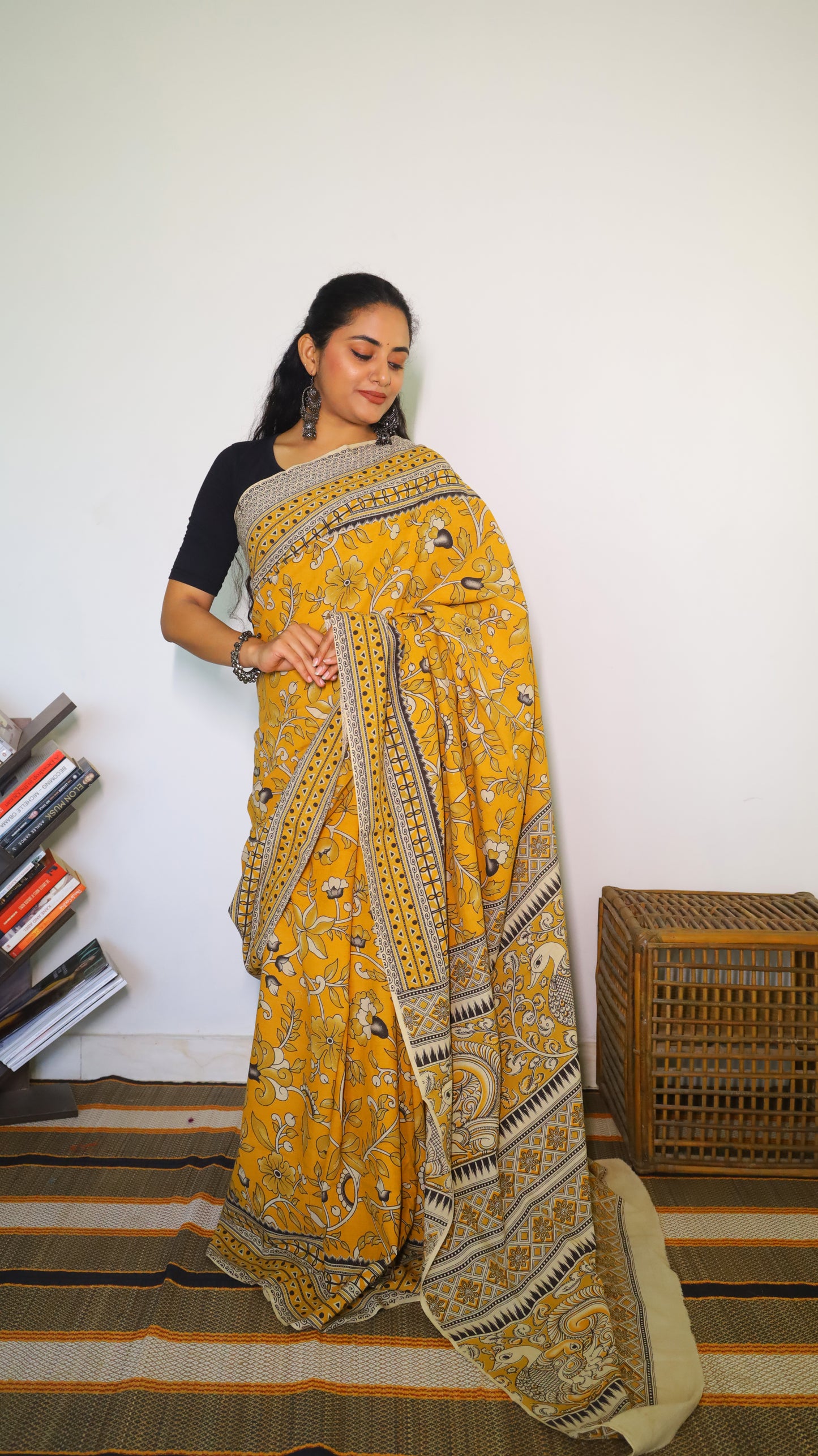 Vibrant mustard yellow soft cotton kalamkari saree featuring flowers and peacocks in light grey and black - BOOMIKA