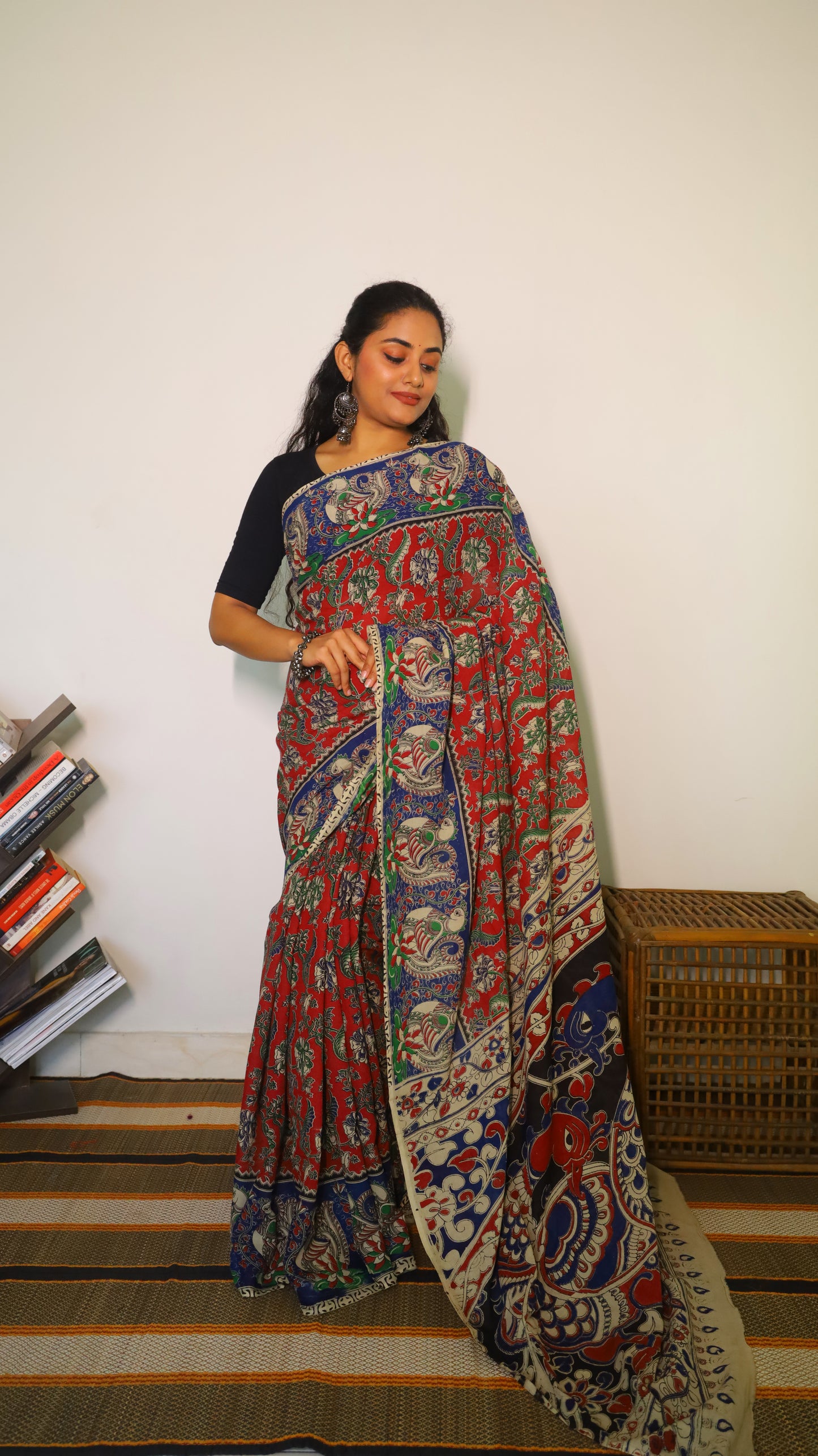 Breathable soft cotton Kalamkari saree with a maroon base featuring floral motifs and navy blue peacock border - BOOMIKA