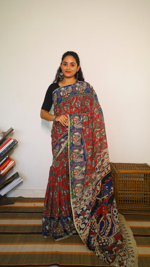 Breathable soft cotton Kalamkari saree with a maroon base featuring floral motifs and navy blue peacock border - BOOMIKA