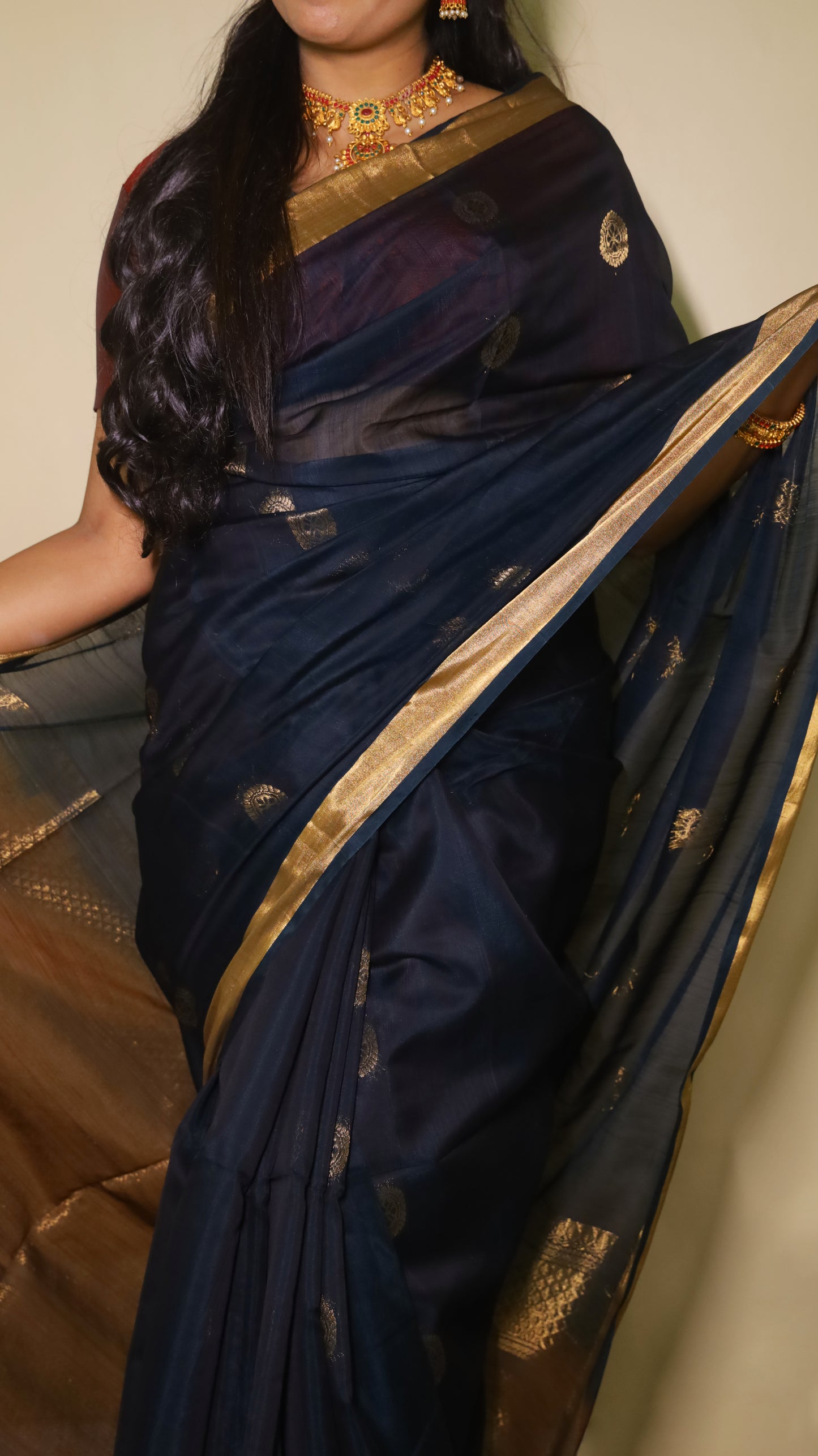 Exquisite silk cotton saree in bottle green and reddish maroon, handwoven with intricate designs - SWASTHIKA