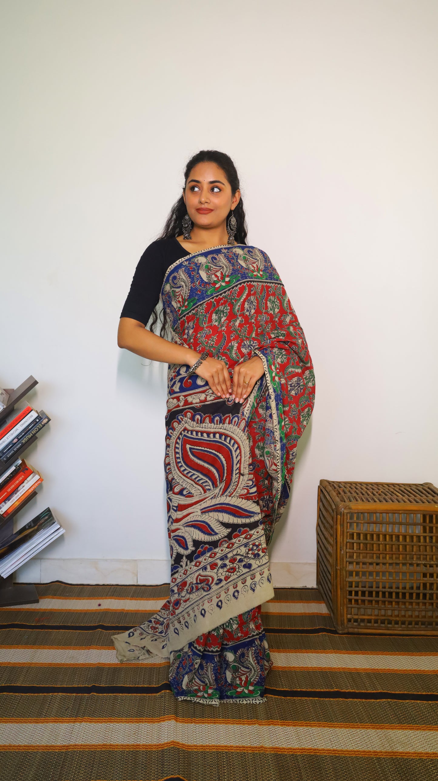 Breathable soft cotton Kalamkari saree with a maroon base featuring floral motifs and navy blue peacock border - BOOMIKA