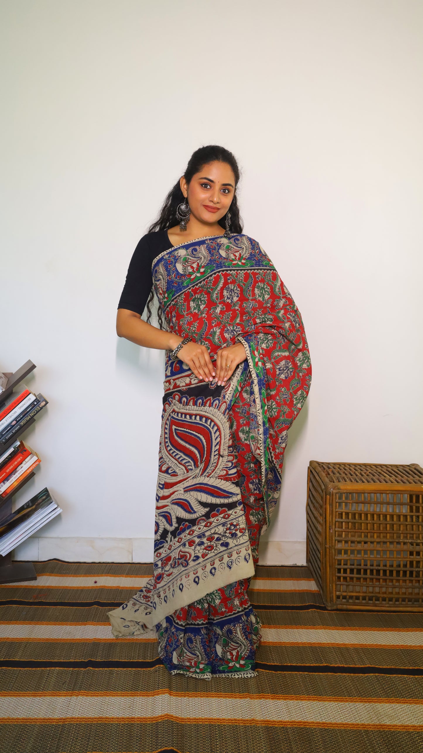 Breathable soft cotton Kalamkari saree with a maroon base featuring floral motifs and navy blue peacock border - BOOMIKA