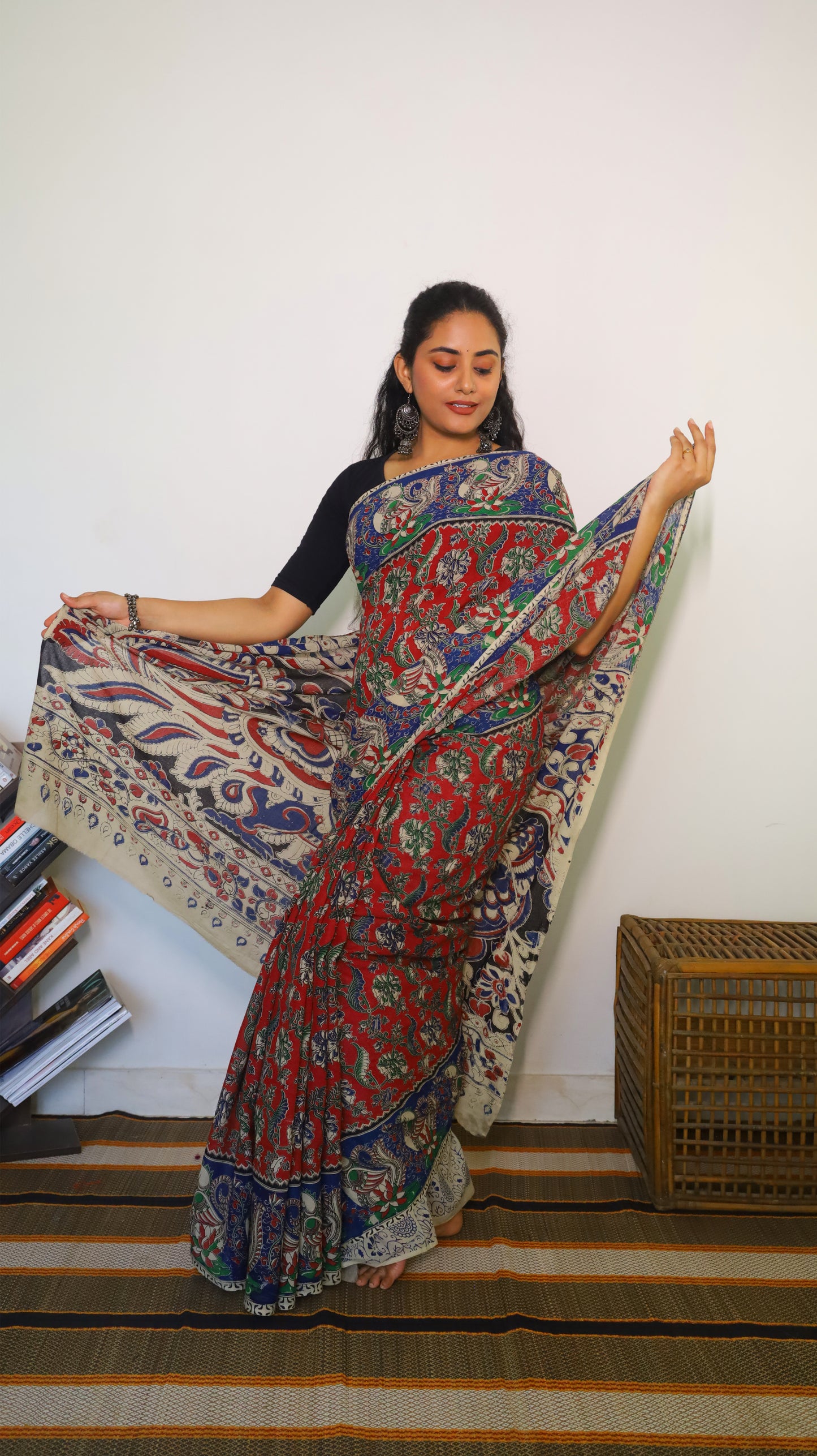 Breathable soft cotton Kalamkari saree with a maroon base featuring floral motifs and navy blue peacock border - BOOMIKA