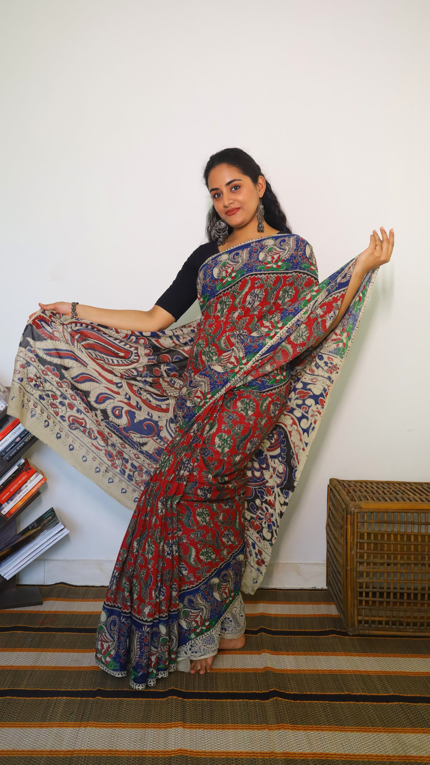 Breathable soft cotton Kalamkari saree with a maroon base featuring floral motifs and navy blue peacock border - BOOMIKA