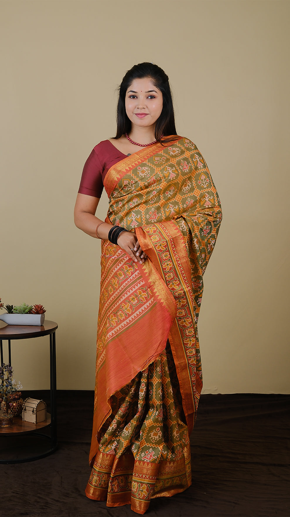 Soft silk patolla print in light olive green and orange with double zari border - AVANTHIKA (20010019)