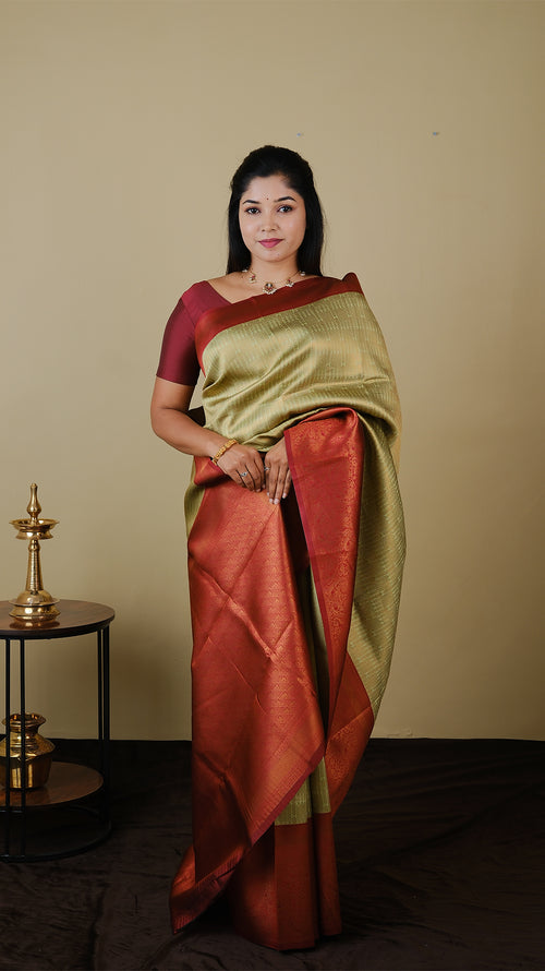 Soft silk brocade in pistha green with all over jal gold zari and gold motif body and chilli red contrast pallu with double border - AVANTHIKA (20009011)