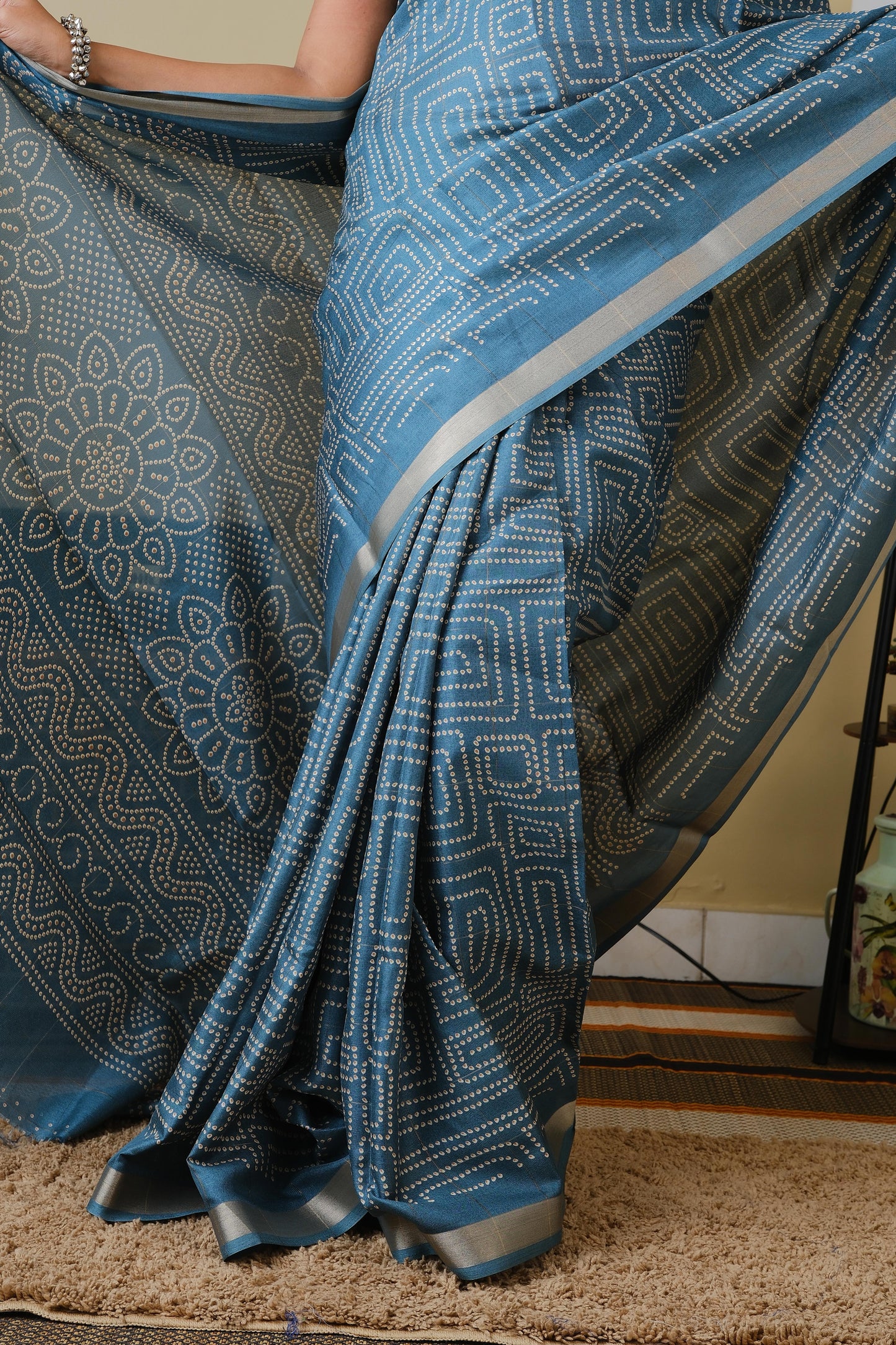 Soft silk in teal green with white sungudi butta pattern and gold zari border - AVANTHIKA