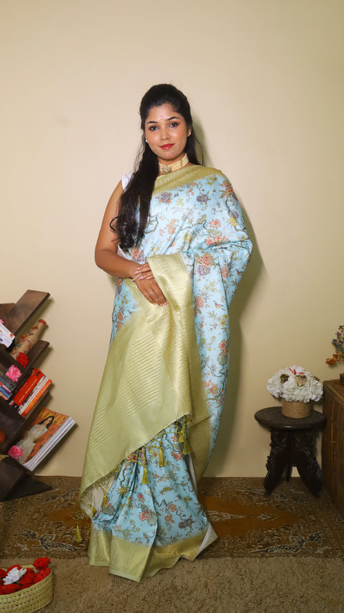 Luxurious Soft Silk Printed Saree with a serene light blue body, with intricate Lepakshi prints and gold satin border - AVANTHIKA