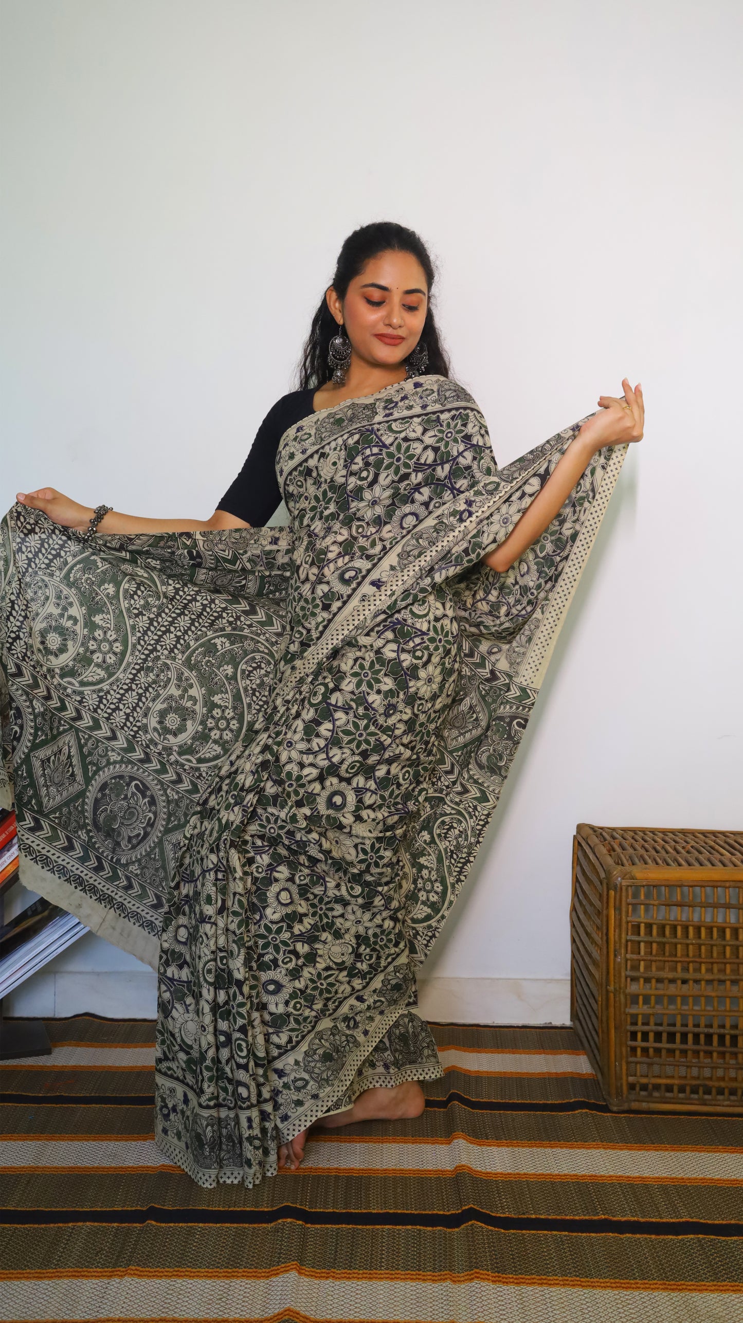 Artisanal black base kalamkari cotton saree with delicate beige, green and blue motifs blossoming - BOOMIKA