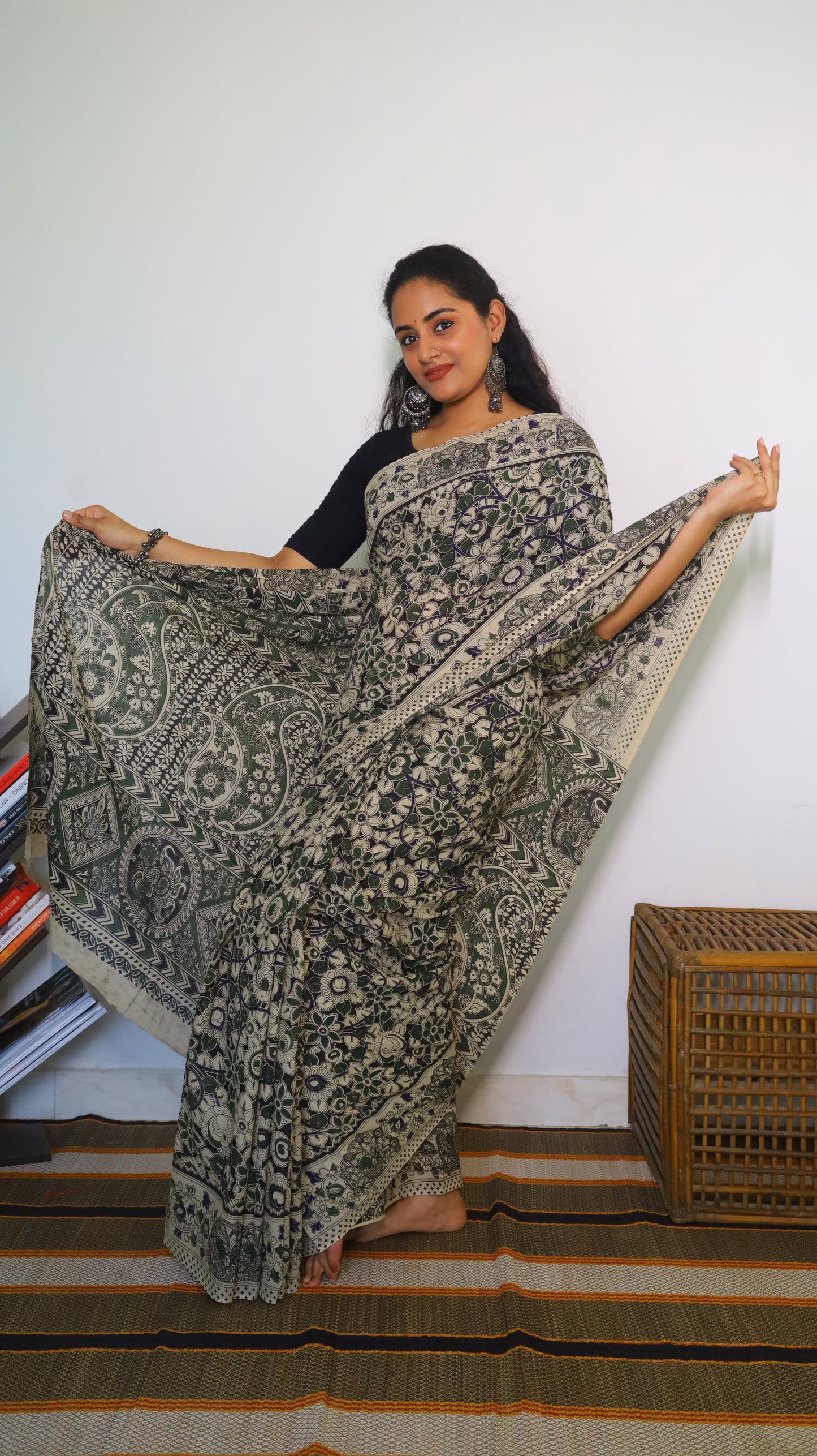Artisanal black base kalamkari cotton saree with delicate beige, green and blue motifs blossoming - BOOMIKA