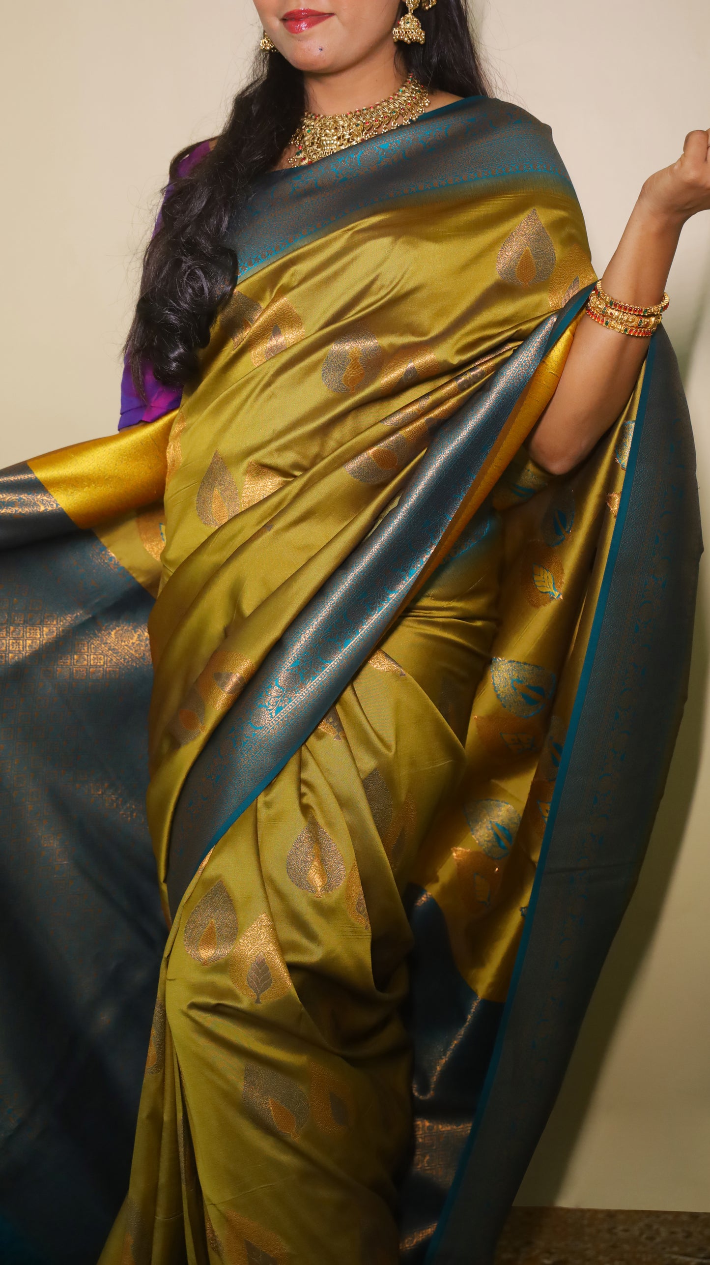 Finest chutney green saree with gold and silver motifs and a turquoise blue border - AVANTHIKA