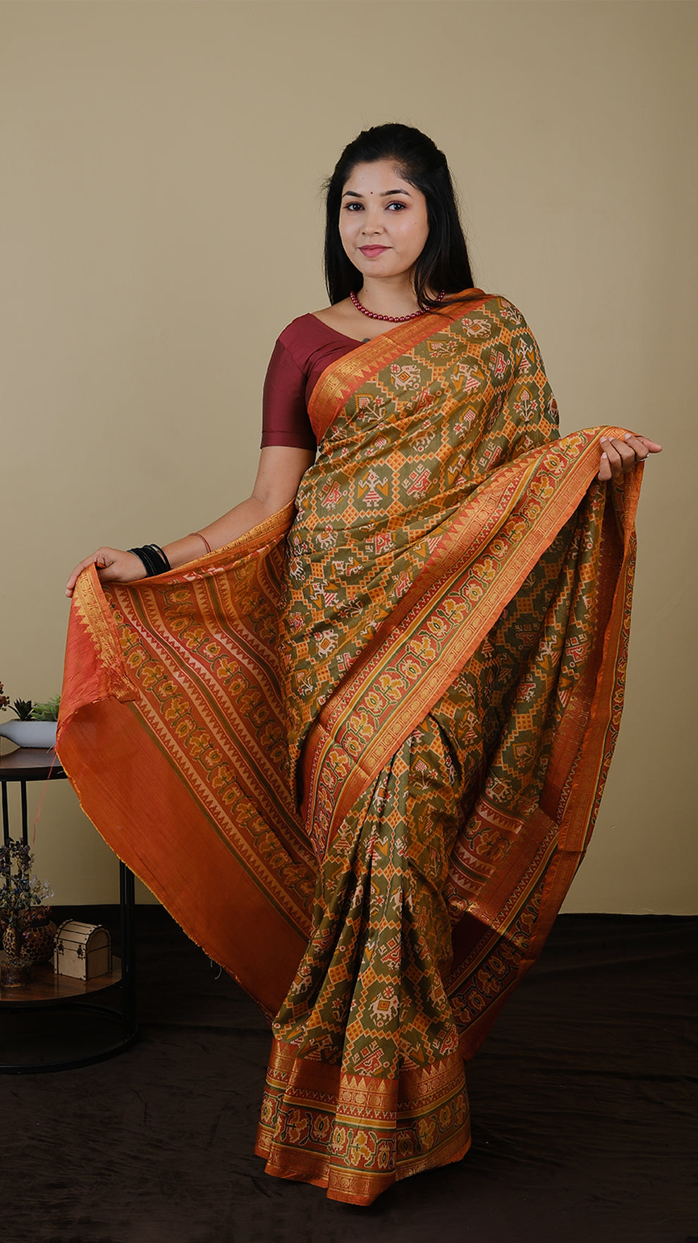 Soft silk patolla print in light olive green and orange with double zari border - AVANTHIKA (20010019)