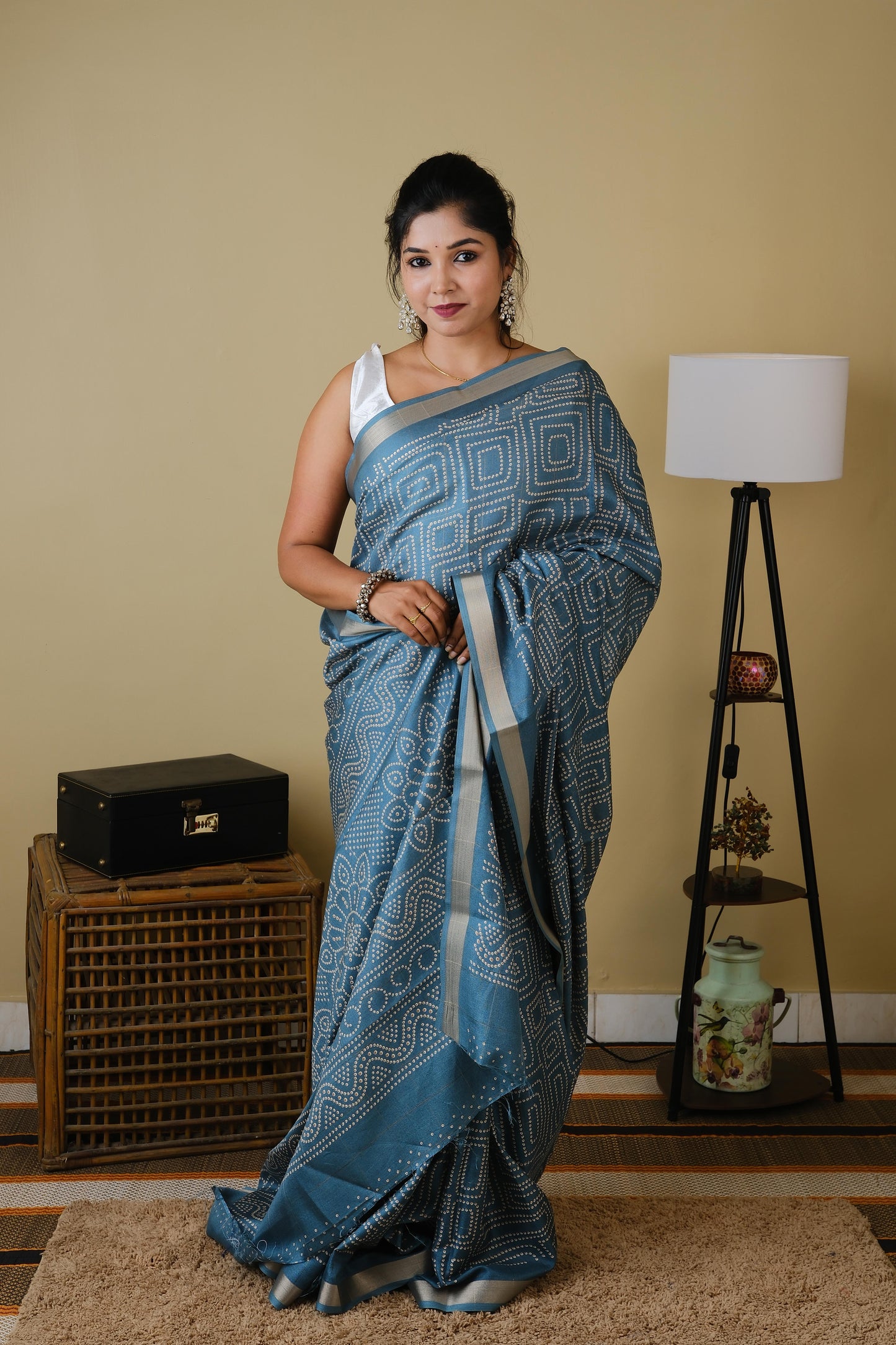 Soft silk in teal green with white sungudi butta pattern and gold zari border - AVANTHIKA