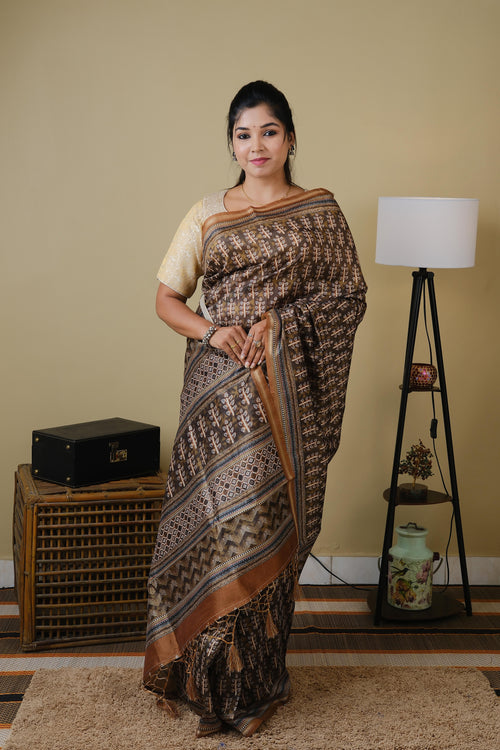 Synthetic organza in olive brown with all over ethnic prints and simple zari border - BOOMIKA