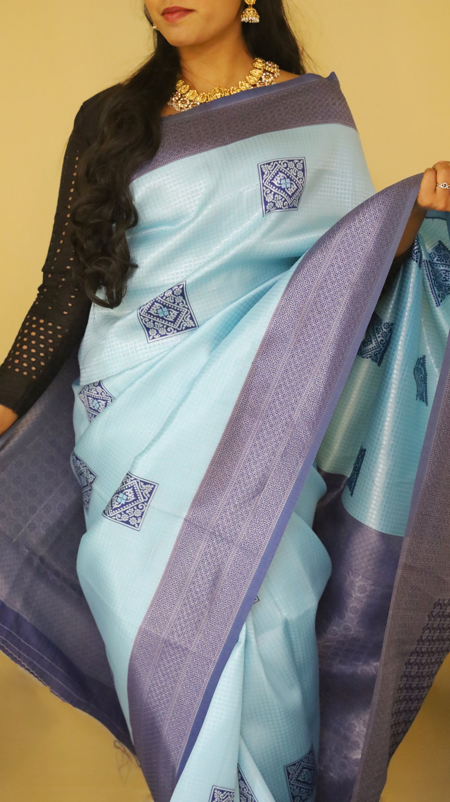 Graceful Soft Silk Saree with a soft light blue body, adorned with delicate buttas, and complemented by a bold dark blue border and pallu - AVANTHIKA
