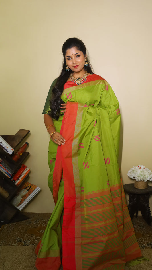 Elegant light green Pasmina silk saree adorned with delicate pink woven motifs, and contrasting pink-gold border - AVANTHIKA