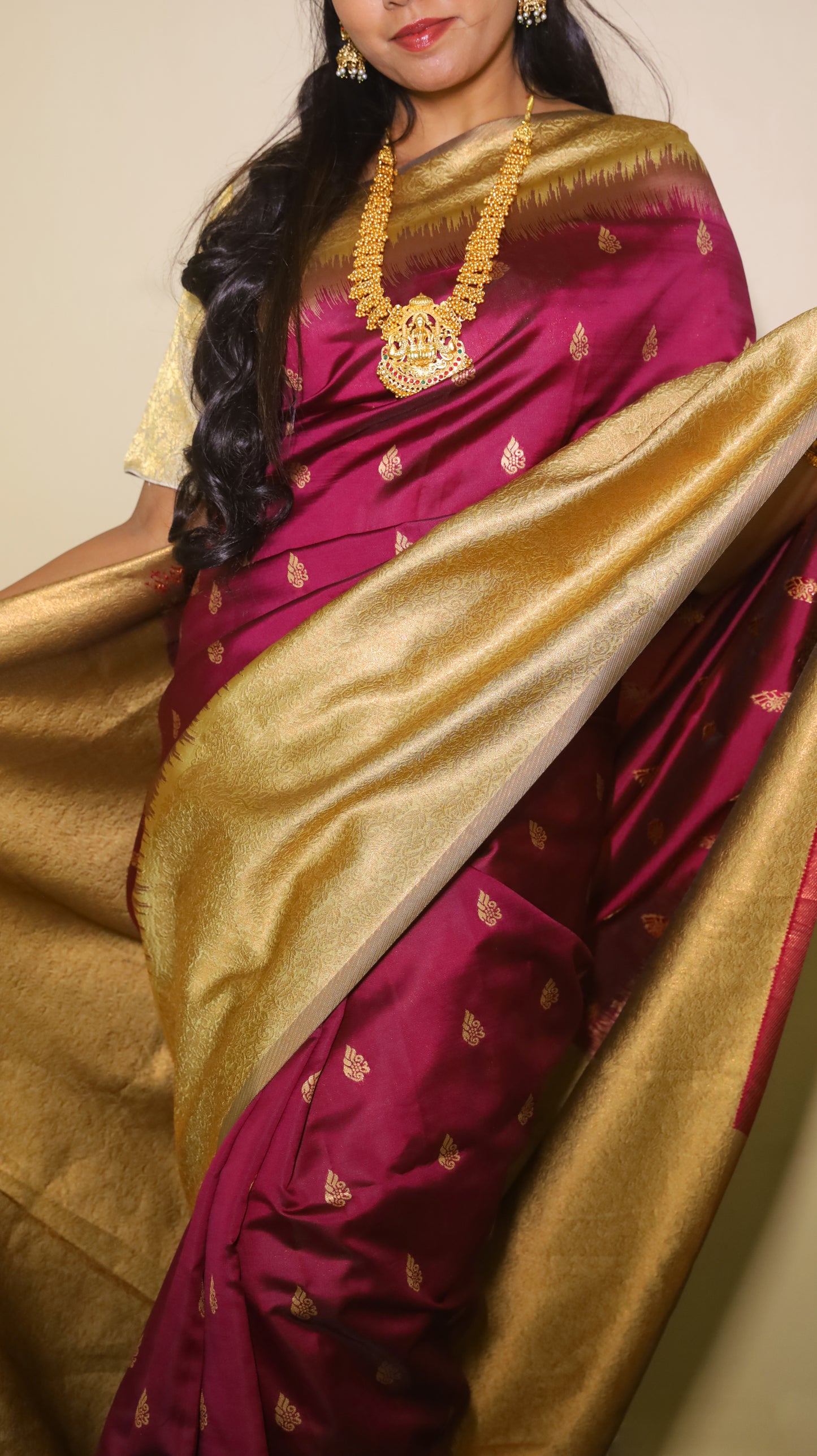 Graceful Soft Silk Saree in a rich maroonish wine body with gold zari border and delicate buttas - AVANTHIKA
