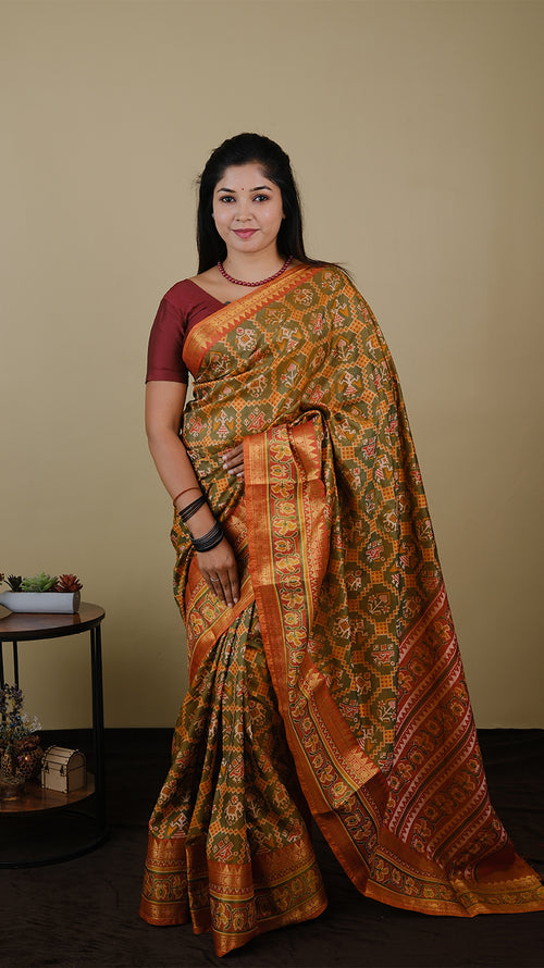 Soft silk patolla print in light olive green and orange with double zari border - AVANTHIKA (20010019)