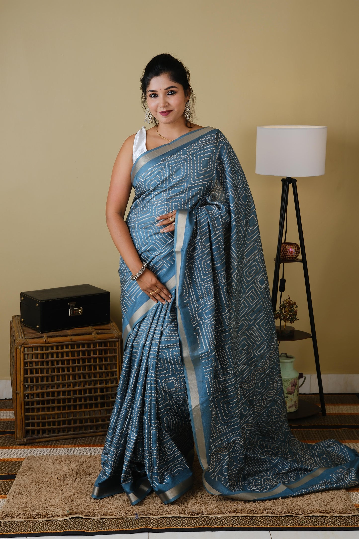 Soft silk in teal green with white sungudi butta pattern and gold zari border - AVANTHIKA