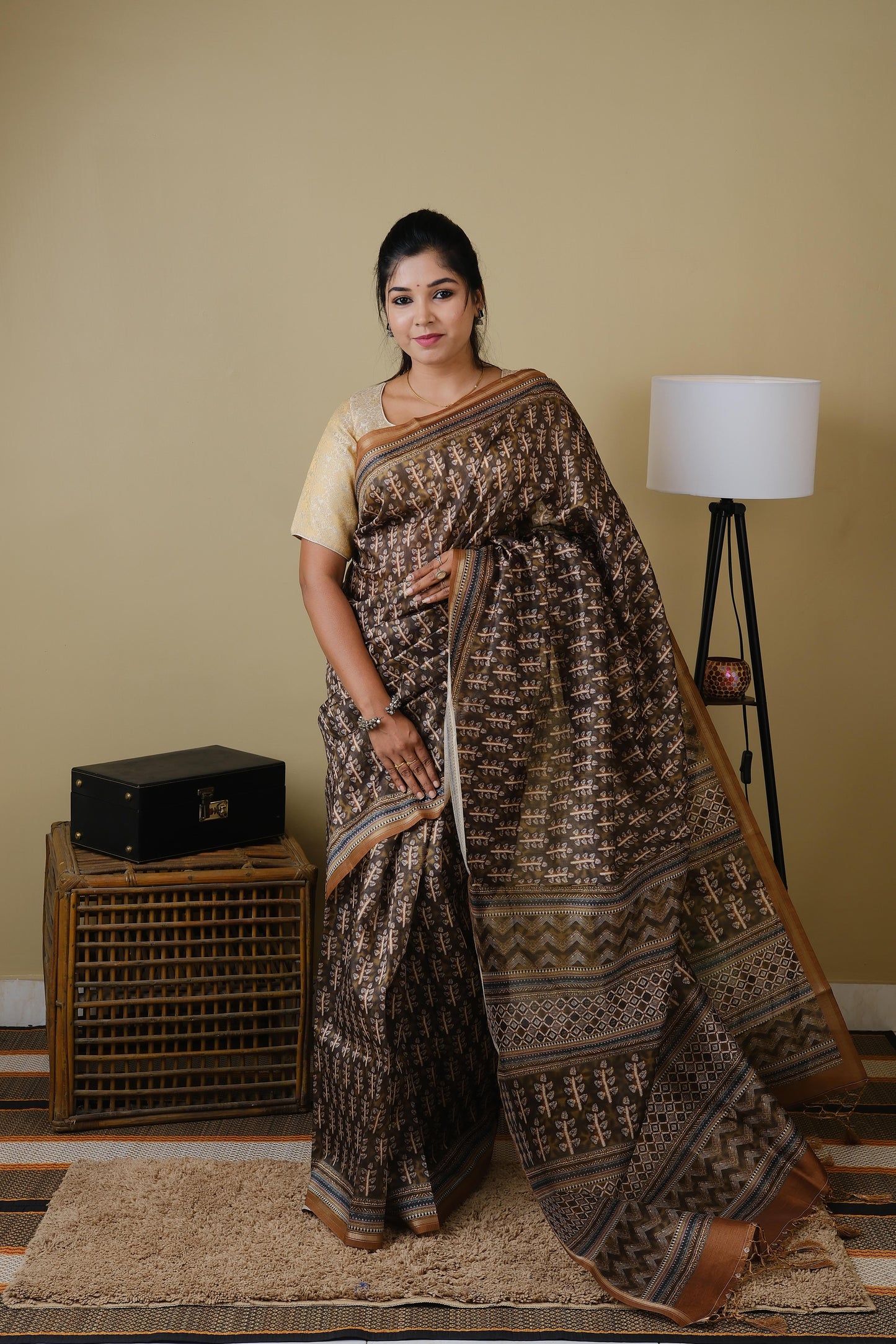 Synthetic organza in olive brown with all over ethnic prints and simple zari border - BOOMIKA