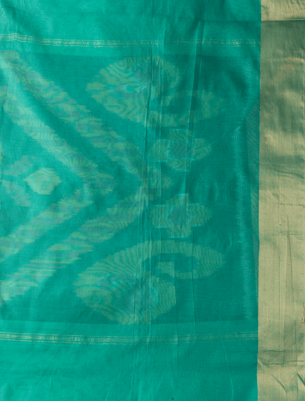 Breathable green silk cotton saree featuring bold Ikat-inspired geometric patterns with tasseled pallu - VEDHIKA