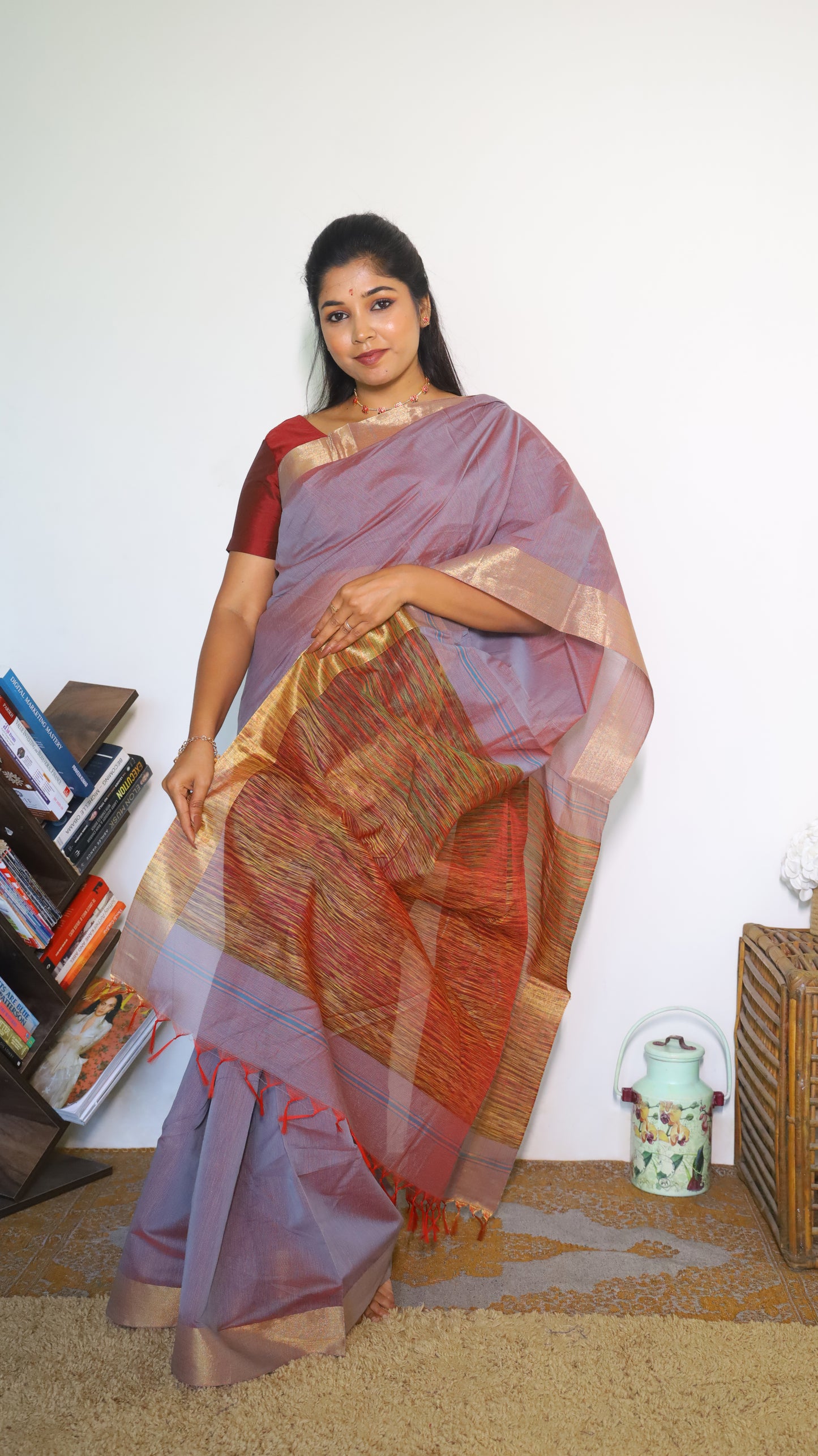 Lightweight maroon Jute Cotton saree with a textured multicolored weave across the body with tasseled pallu and muted border which gives a subtle festive look - BOOMIKA