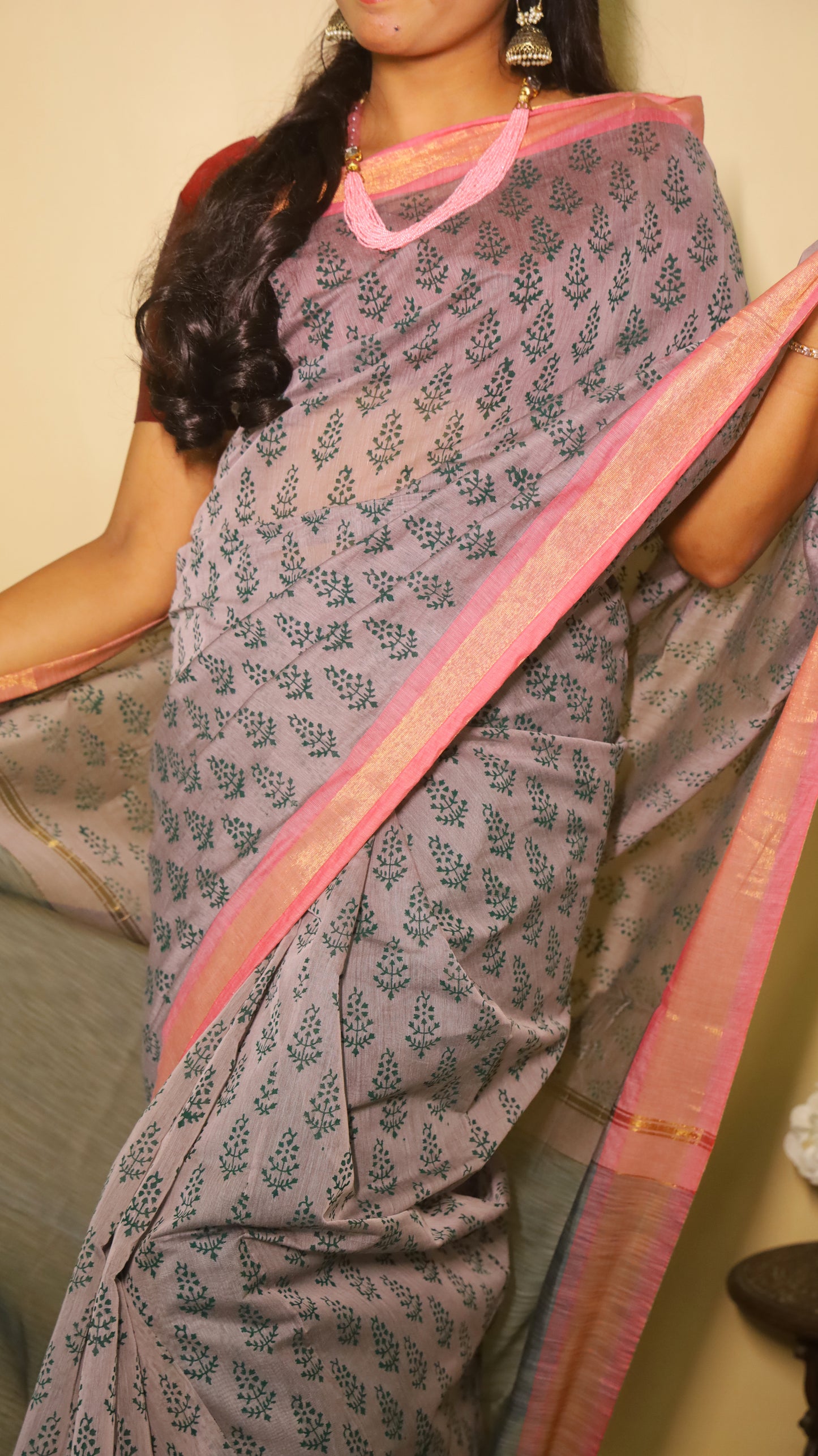 Handprinted manipuri cotton saree patterned with delicate green floral buttas, soft pink border and tasseled edge - BOOMIKA