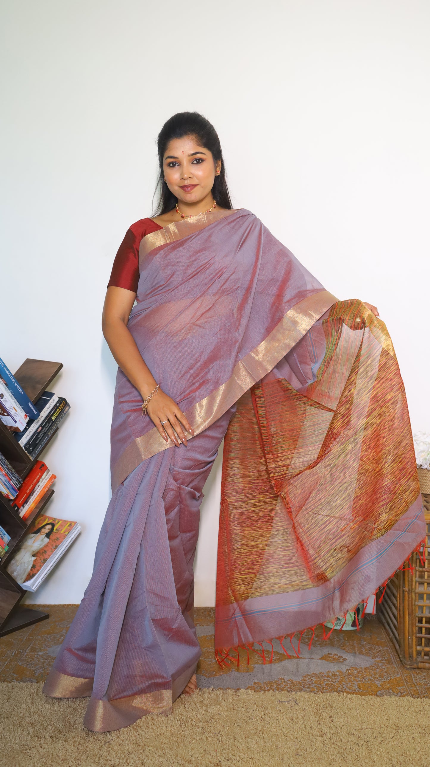 Lightweight maroon Jute Cotton saree with a textured multicolored weave across the body with tasseled pallu and muted border which gives a subtle festive look - BOOMIKA