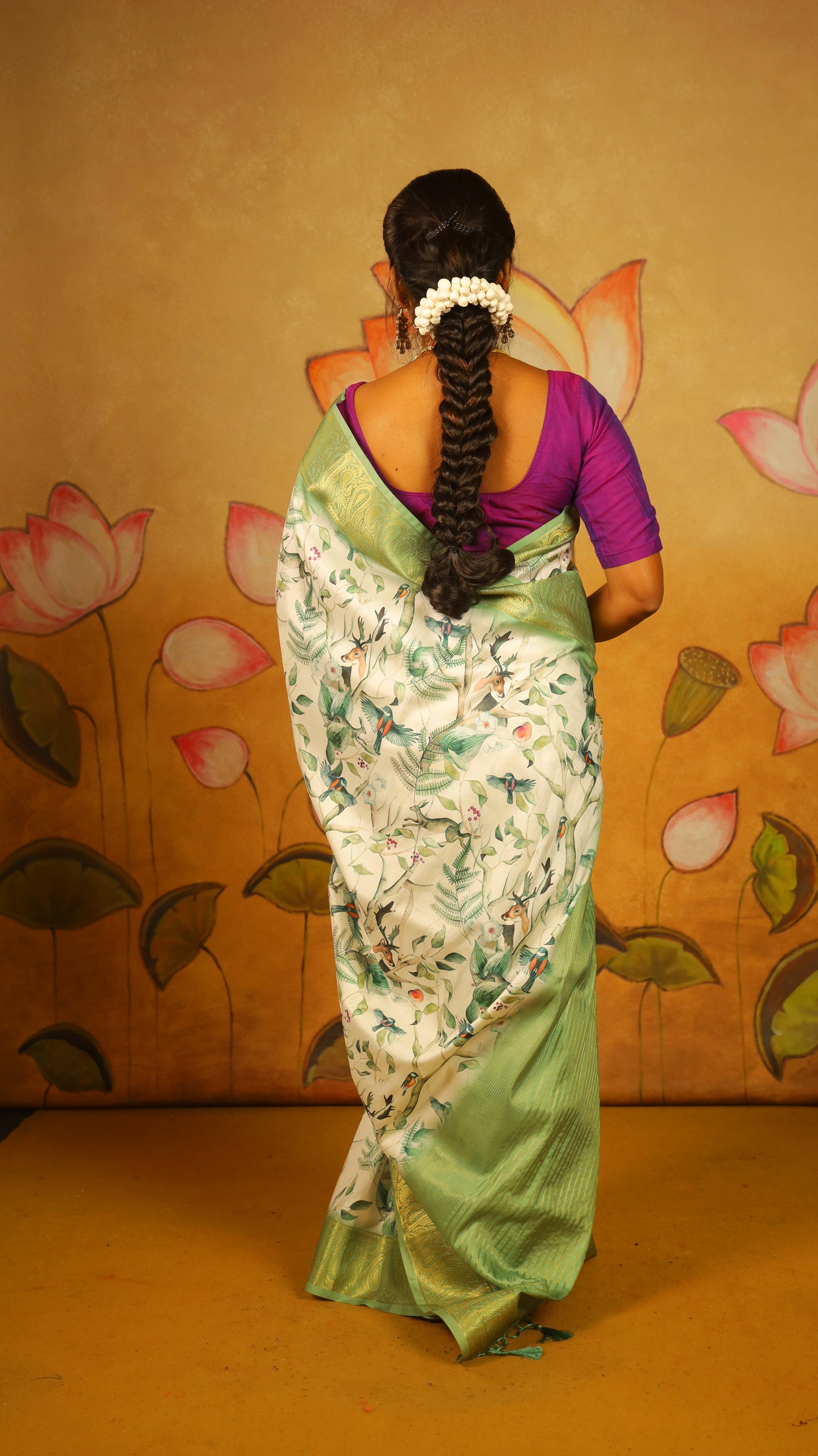 Elegant Soft Silk Saree with a pure white body, complemented by a fresh green border and pallu featuring intricate Lepakshi prints. Statement stylish blend of tradition and style - AVANTHIKA