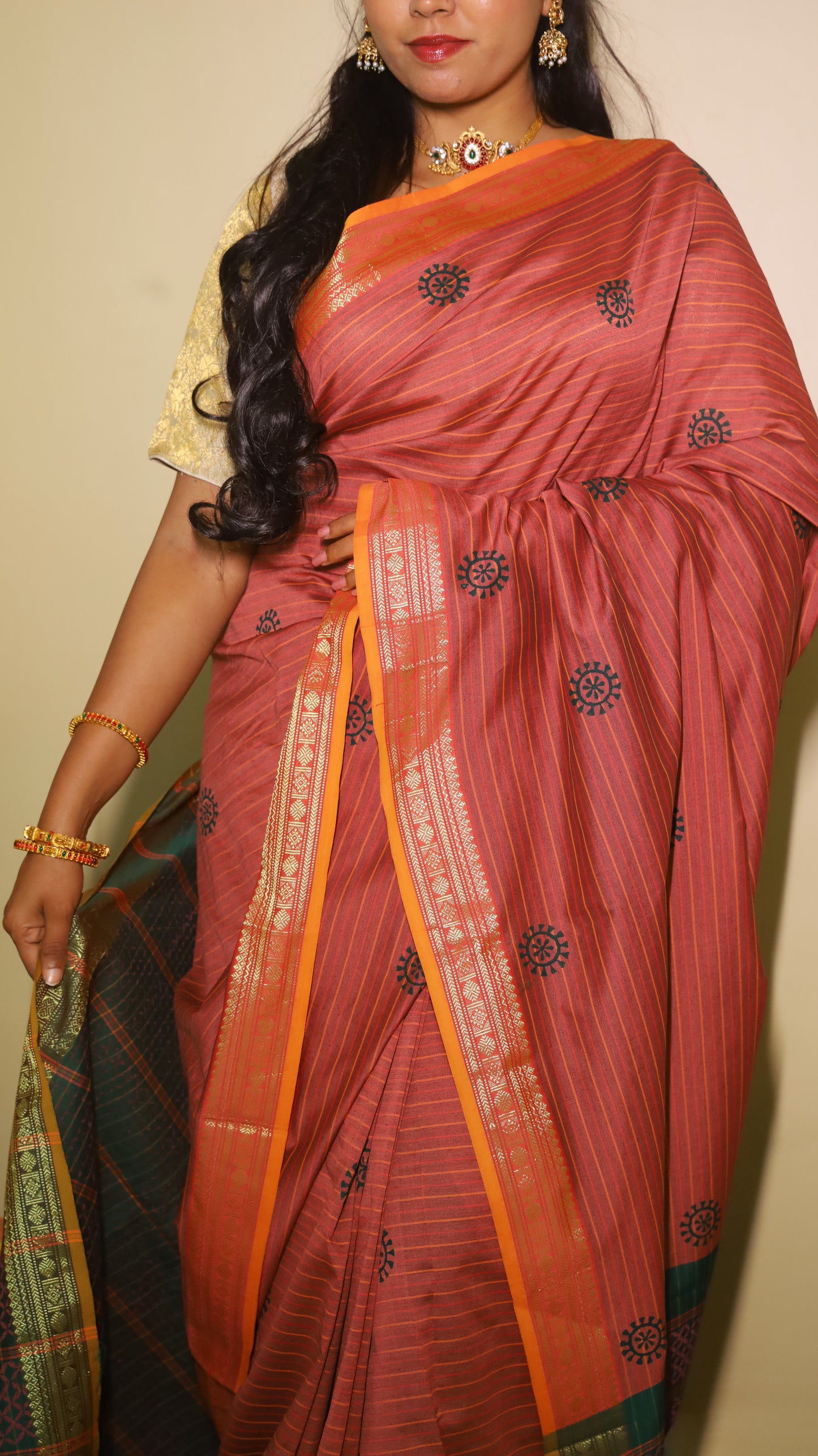 Timeless maroon saree with subtle linear texture, bold navy-blue sun motifs and with a dual-tone zari border in orange and green - VARSHIKA