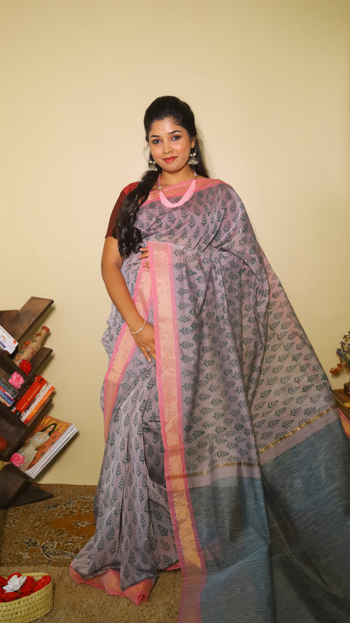 Handprinted manipuri cotton saree patterned with delicate green floral buttas, soft pink border and tasseled edge - BOOMIKA