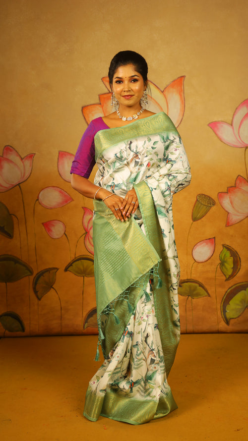 Elegant Soft Silk Saree with a pure white body, complemented by a fresh green border and pallu featuring intricate Lepakshi prints. Statement stylish blend of tradition and style - AVANTHIKA