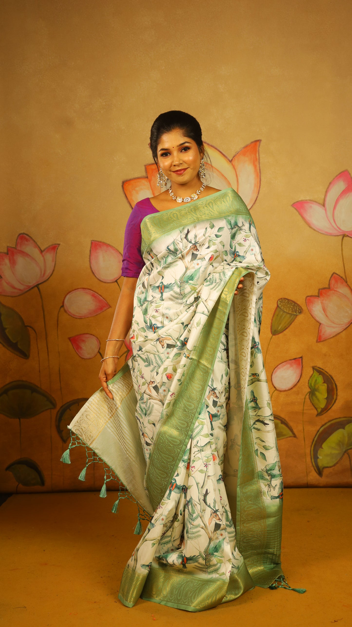 Elegant Soft Silk Saree with a pure white body, complemented by a fresh green border and pallu featuring intricate Lepakshi prints. Statement stylish blend of tradition and style - AVANTHIKA