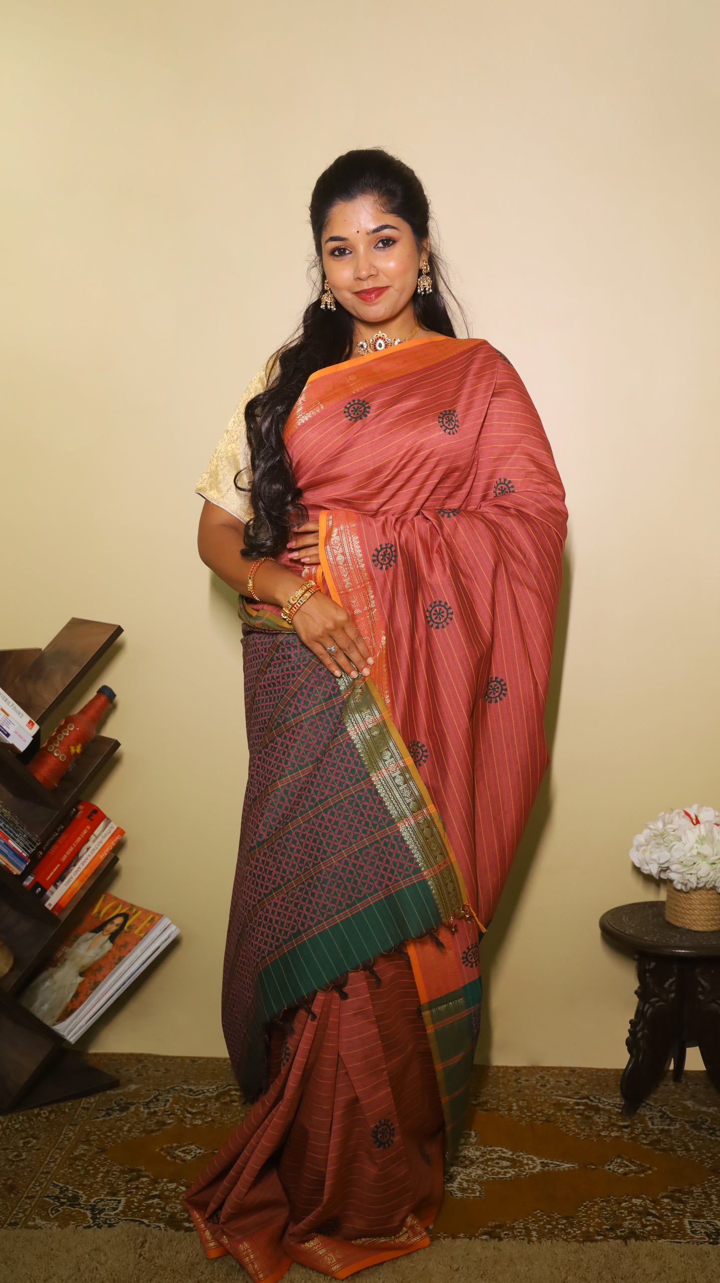 Timeless maroon saree with subtle linear texture, bold navy-blue sun motifs and with a dual-tone zari border in orange and green - VARSHIKA