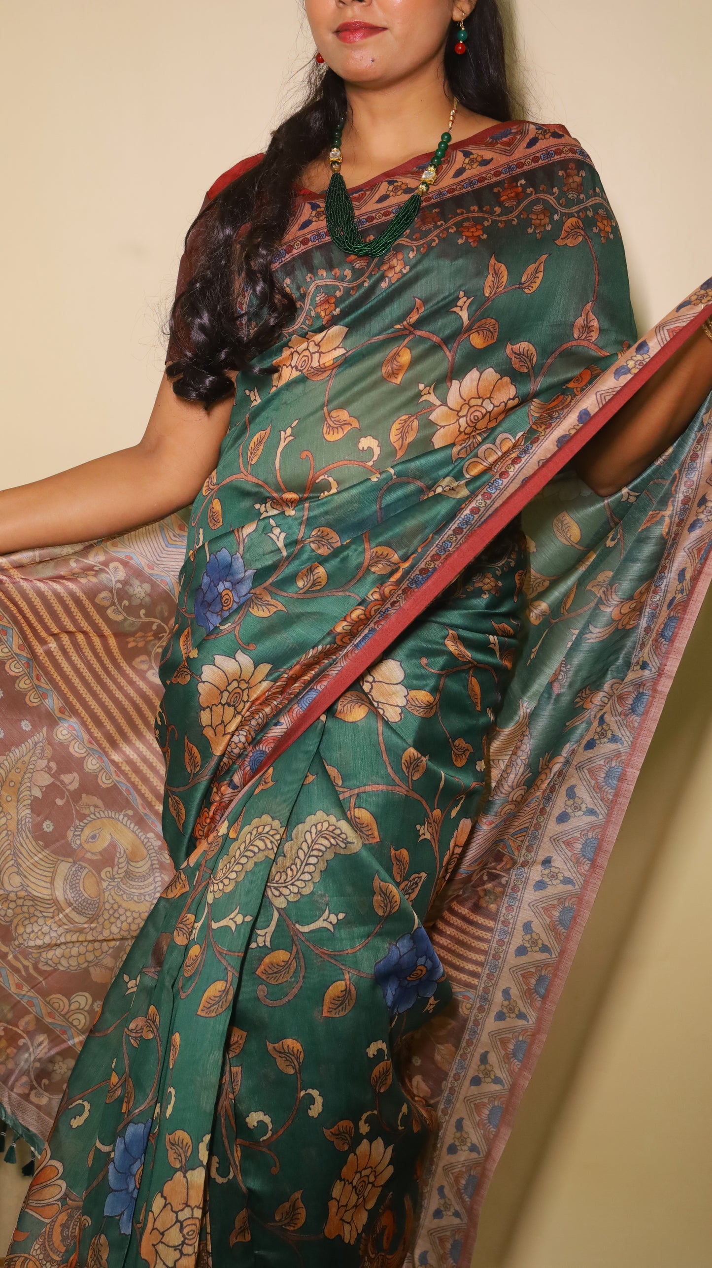 Exquisite deep bottle green silk cotton saree with floral and peacock motifs, paired with a maroon border - VEDHIKA