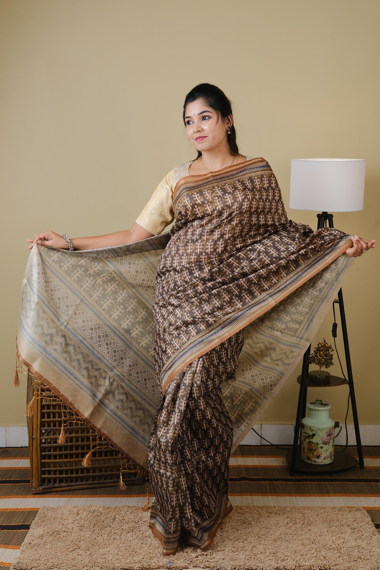 Synthetic organza in olive brown with all over ethnic prints and simple zari border - BOOMIKA