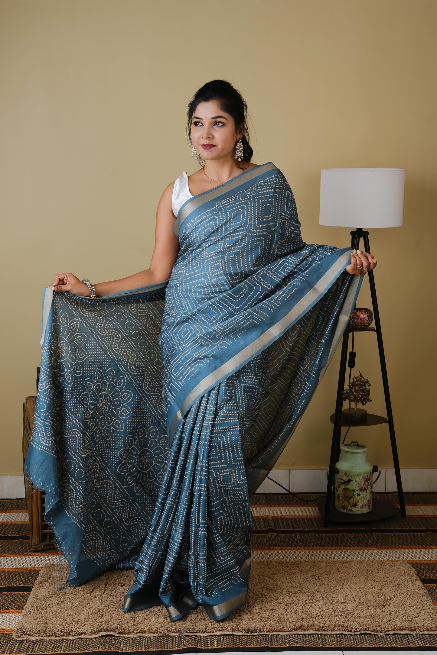 Soft silk in teal green with white sungudi butta pattern and gold zari border - AVANTHIKA