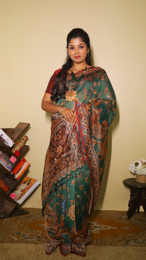 Exquisite deep bottle green silk cotton saree with floral and peacock motifs, paired with a maroon border - VEDHIKA