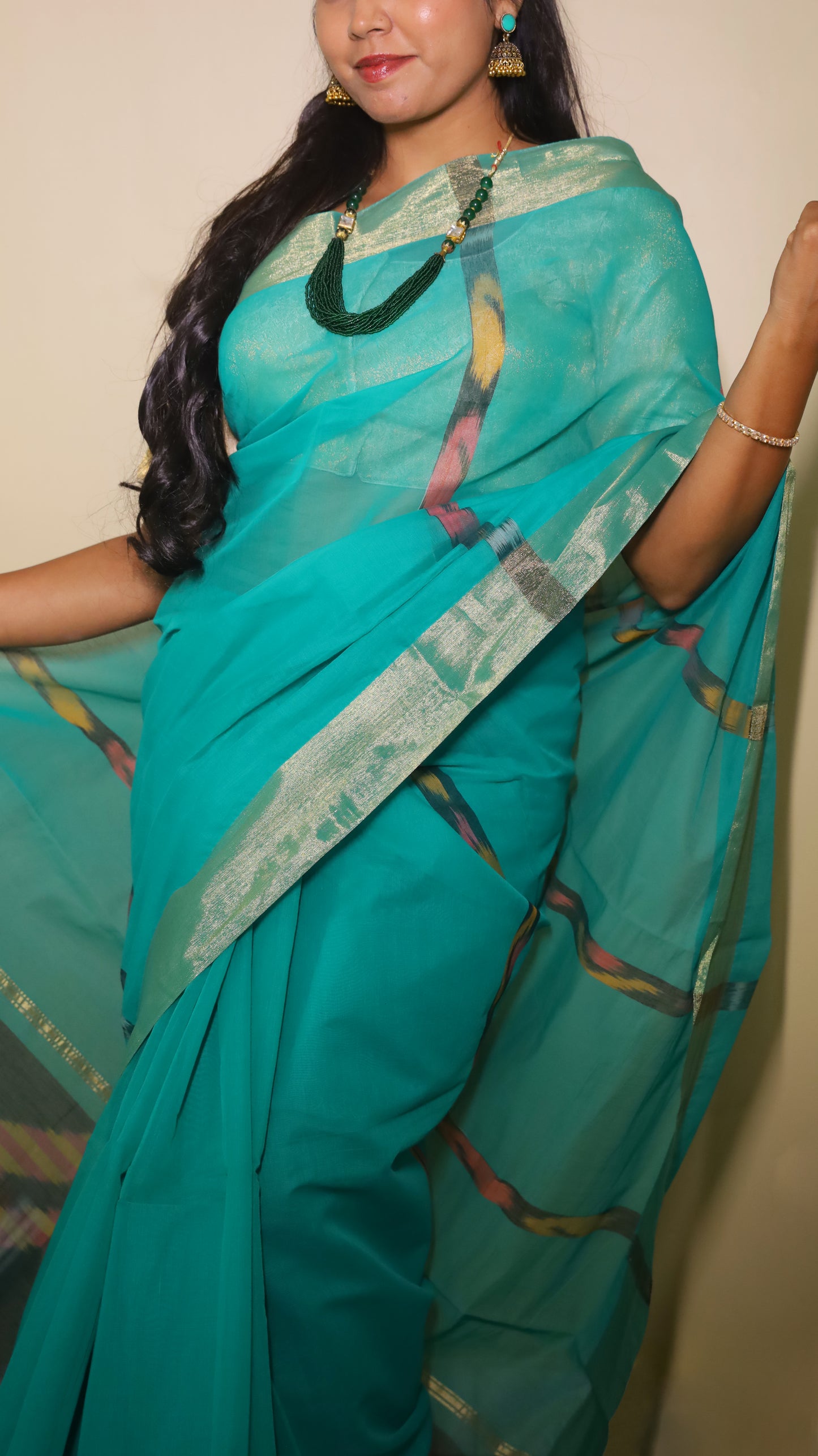 Breathable green silk cotton saree featuring bold Ikat-inspired geometric patterns with tasseled pallu - VEDHIKA