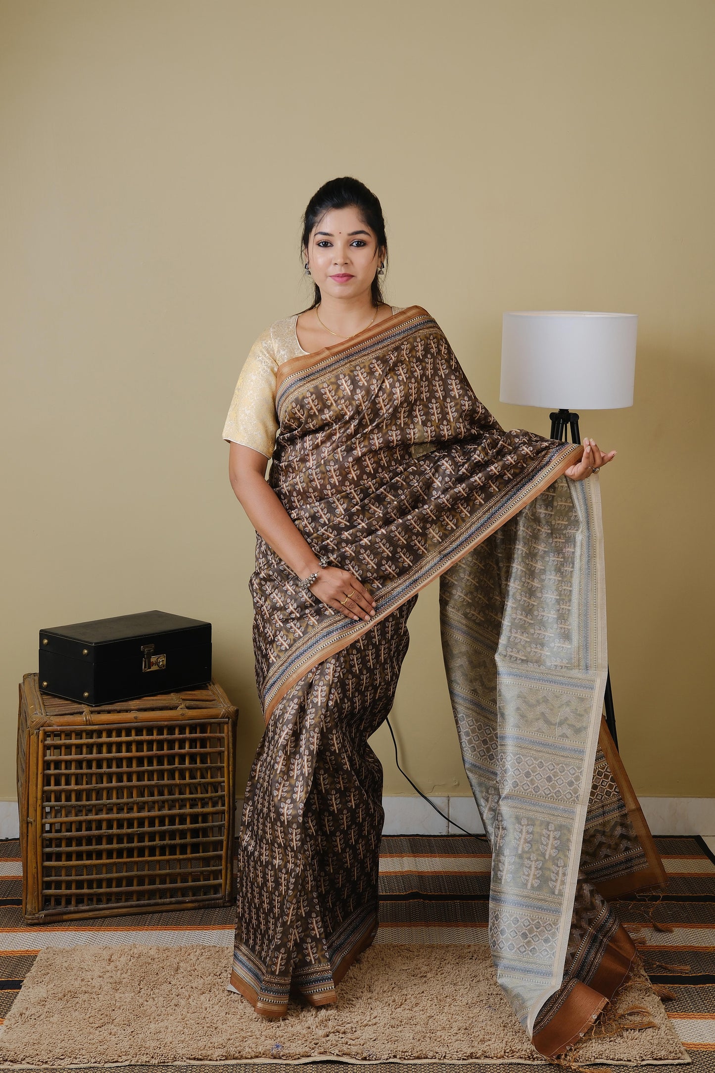 Soft cotton in black with golden tribal prints and pinkish brown border - BOOMIKA