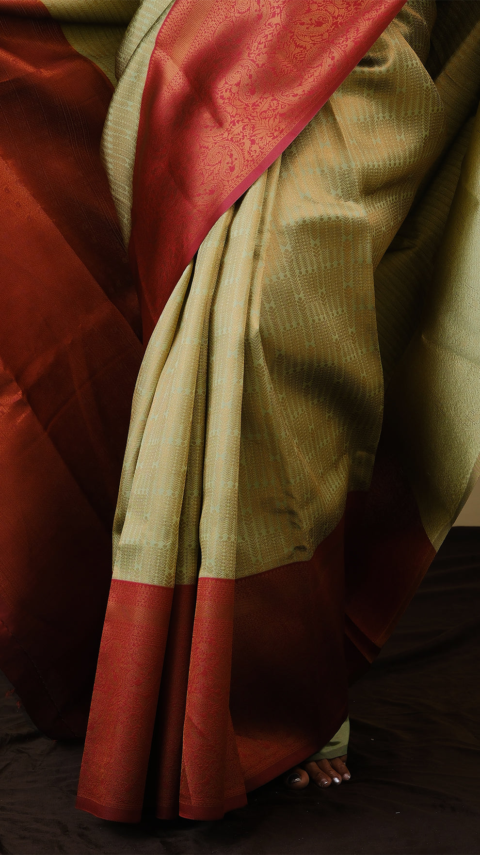 Soft silk brocade in pistha green with all over jal gold zari and gold motif body and chilli red contrast pallu with double border - AVANTHIKA (20009011)
