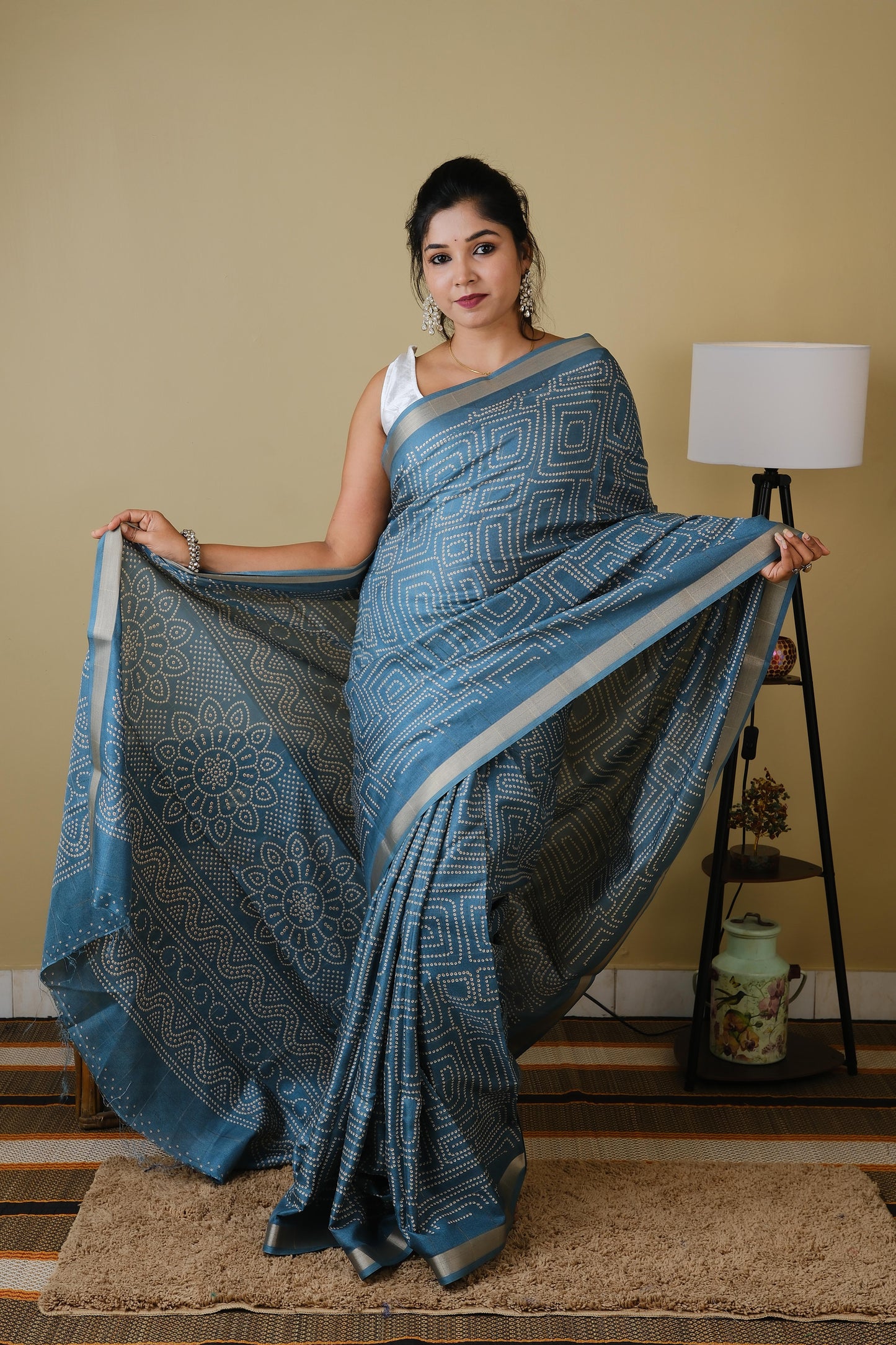 Soft silk in teal green with white sungudi butta pattern and gold zari border - AVANTHIKA
